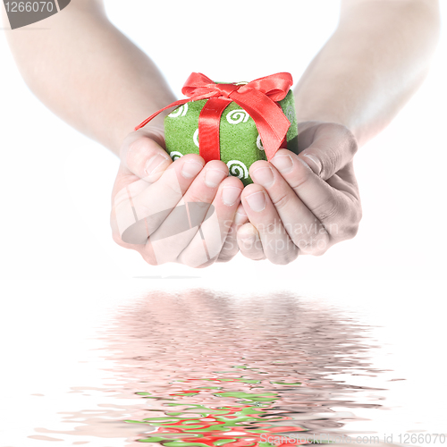 Image of Hands holding gift with reflection isolated on white