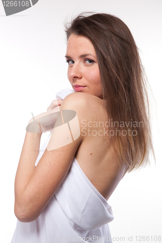 Image of Attractive woman covered in white cloth on white