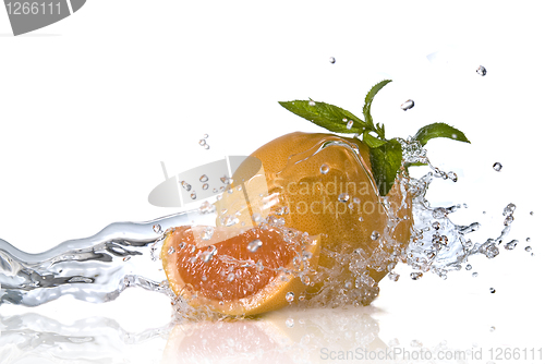 Image of Water splash on orange with mint isolated on white