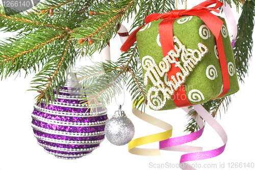 Image of Christmas balls, gift and decoration on fir tree branch isolated