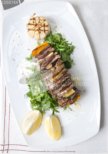 Image of shashlik with potherbs on the plate