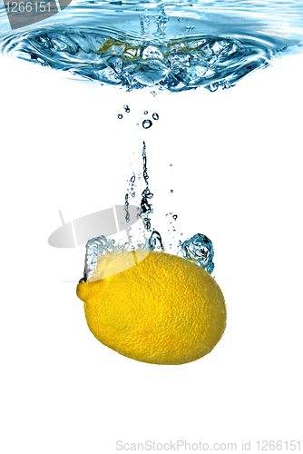 Image of Fresh lemon dropped into water with bubbles isolated on white