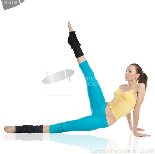 Image of attractive woman doing gymnastics on white background