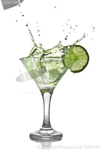 Image of Green alcohol cocktail with splash and green lime isolated on wh