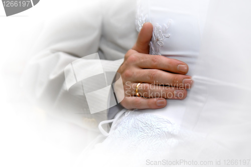 Image of Just Married. Grooms hand with gold ring