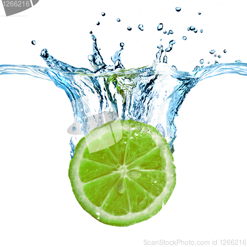 Image of Fresh lime dropped into water with splash isolated on white