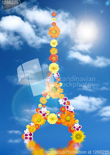 Image of eiffel tower from flowers with reflection and sun against blue s