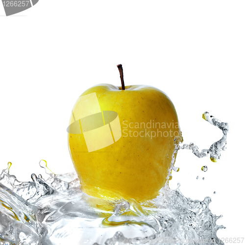 Image of fresh water splash on yellow apple isolated on white