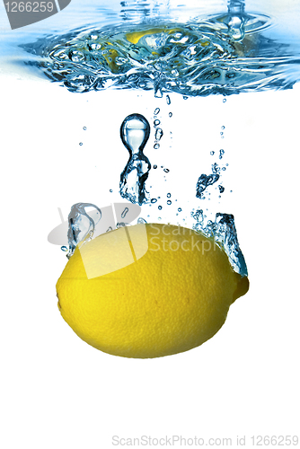 Image of Fresh lemon dropped into water with bubbles isolated on white