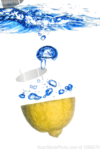 Image of lemon and lime dropped into water with bubbles isolated on white