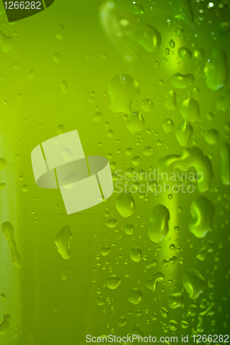 Image of Green beer bottle with water drops isolated on white