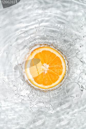 Image of Fresh orange dropped into water with bubbles isolated on white
