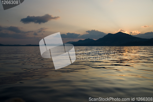 Image of landscape with sea and mountains on sunset