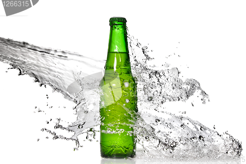 Image of Green beer bottle with water splash isolated on white