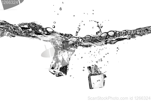 Image of ice cubes dropped into water with splash isolated on white