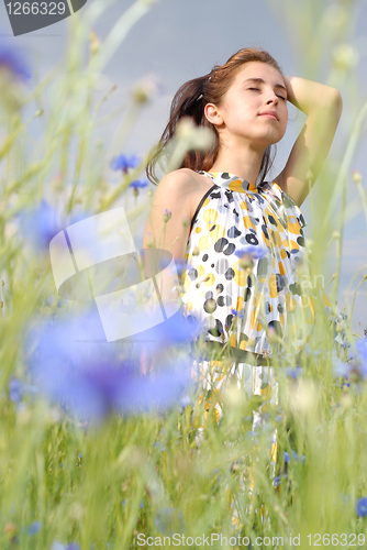 Image of Girl posing in field of flowers