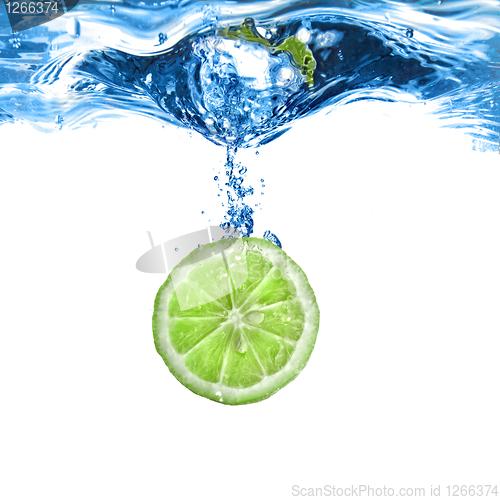 Image of Fresh lime dropped into water with bubbles isolated on white