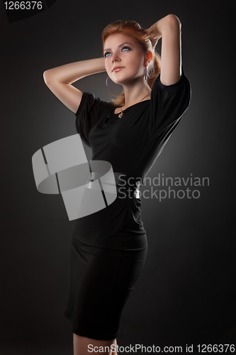 Image of Portrait of attractive young woman on black