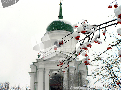 Image of Brunches of ashberry in snow against the church