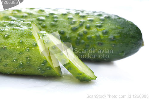 Image of green cucumber with water drops isolated on white