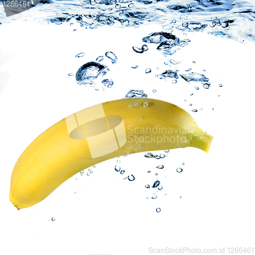 Image of banana dropped into water isolated on white