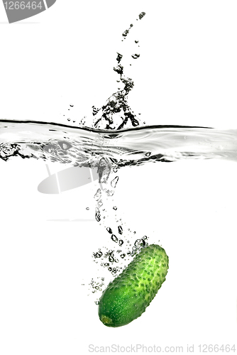 Image of green cucumber dropped into water isolated on white