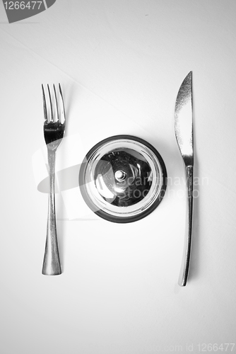 Image of fork and knife on table with restaurant ring