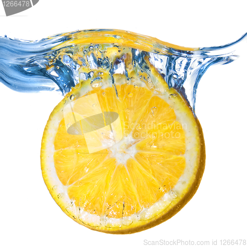 Image of Fresh lemon dropped into water with splash isolated on white