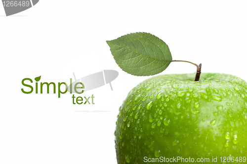 Image of green apple with leaf and water drops isolated on white