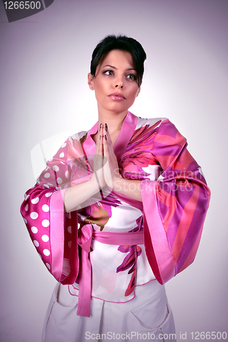 Image of Atrractive girl in kimono pray