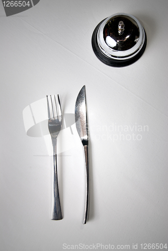 Image of fork and knife on table with restaurant ring