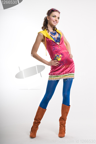 Image of Beautiful young woman posing in color wear