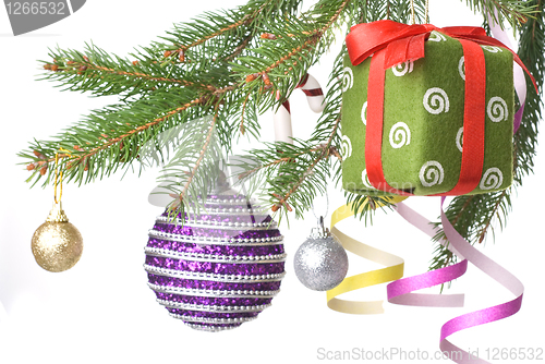 Image of Christmas balls, gift and decoration on fir tree branch isolated