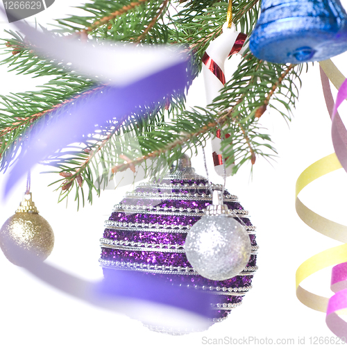 Image of Christmas balls and decoration on fir tree branch isolated on wh
