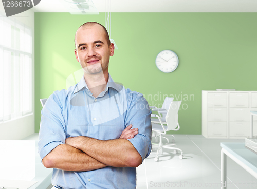 Image of confident worker in office