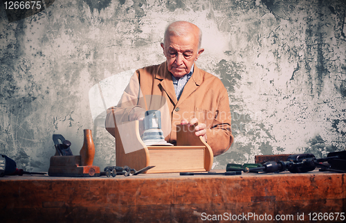 Image of portrait of old caucasian carpenter with grunge background