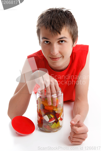 Image of Boy with hand in lolly jar