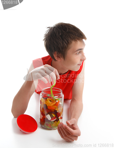 Image of Boy with candy snake looking sideways