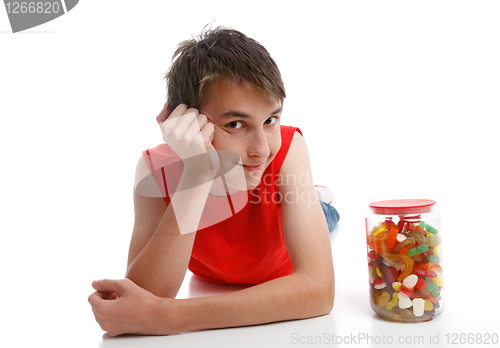 Image of Boy beside an assortment of mixed confectionery