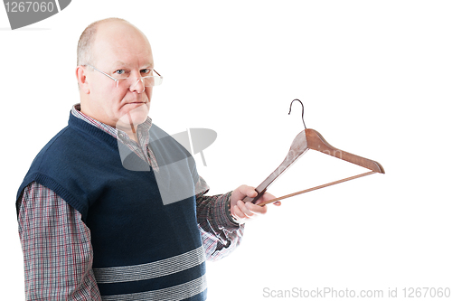 Image of Confident man in glasses holds in hand empty cloth hanger