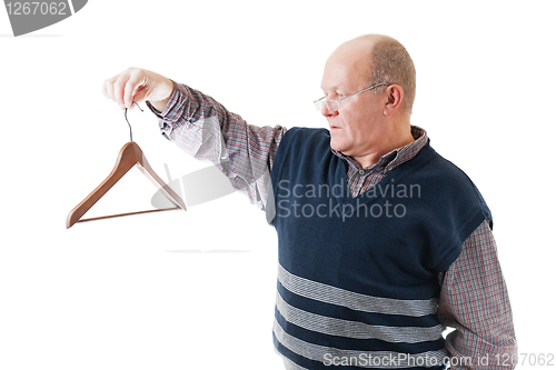 Image of Confident man in glasses holds in hand empty cloth hanger