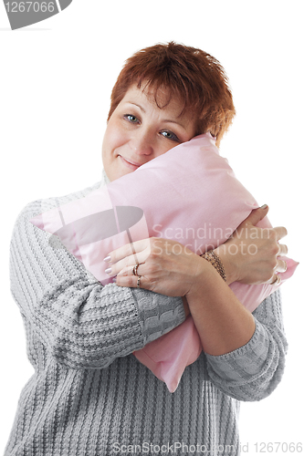 Image of Happy woman hugs pink pillow