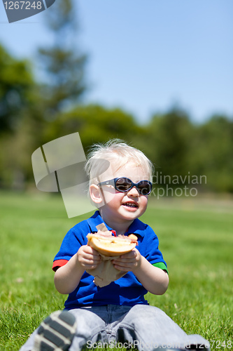 Image of toddler eating sandwich