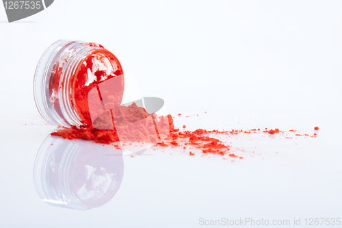 Image of spilled red makeup powder