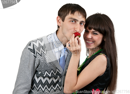Image of woman feeding man strawberries