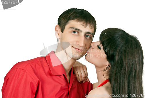 Image of woman kisses a man on the cheek