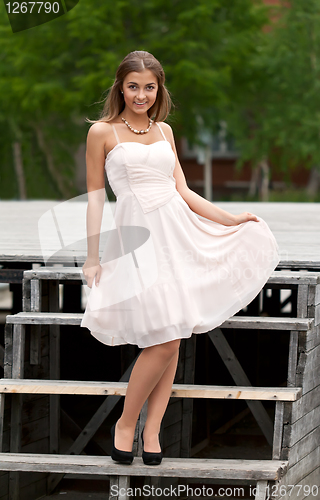 Image of girl on the stairs in a dress