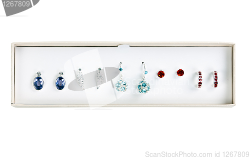 Image of five pairs of earrings with stones