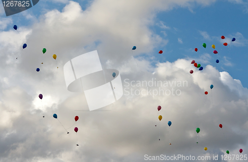 Image of colored balloons flying in the sky