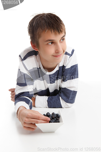 Image of Boy eating blueberries